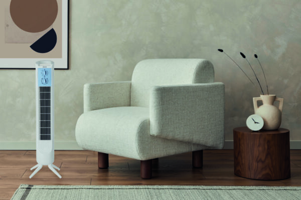 Stylish composition of modern cozy living room interior with structure painting on the wall, beige armchair and personal accessories. Neutral creative wall, carpet on the parquet floor. Template.